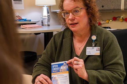 A healthcare navigator shows an Alaskan information about open enrollment.