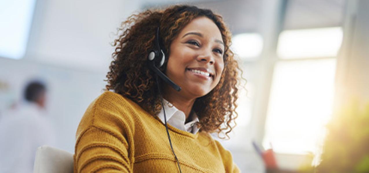 A person takes a call from a call center.