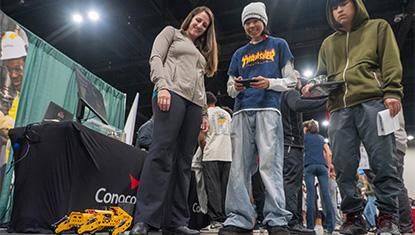 Students test a robot from the Alaska Resource Education display at ASD's Career Fair on Sept. 26, 2025.