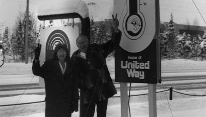 Community Campaign Chairs pose with signage indicating how much Alaskans had raised to help Anchorage working families thrive.